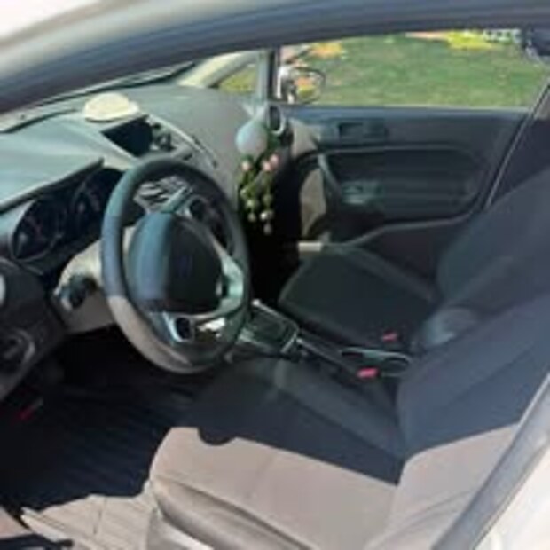 The same Ford Fiesta front seats and floor after a full interior detail
