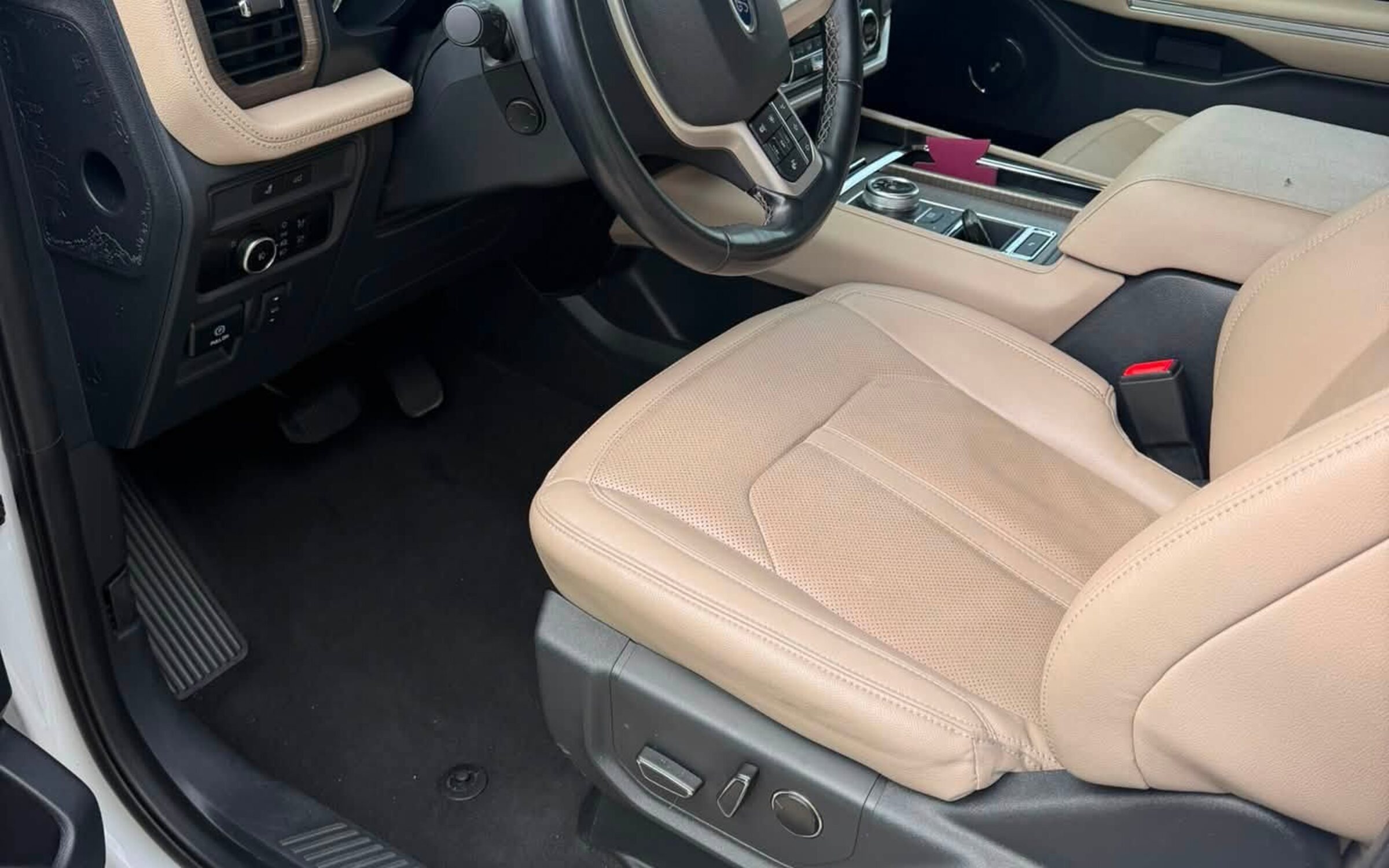 A freshly detailed SUV interior with clean tan leather seats and spotless carpet