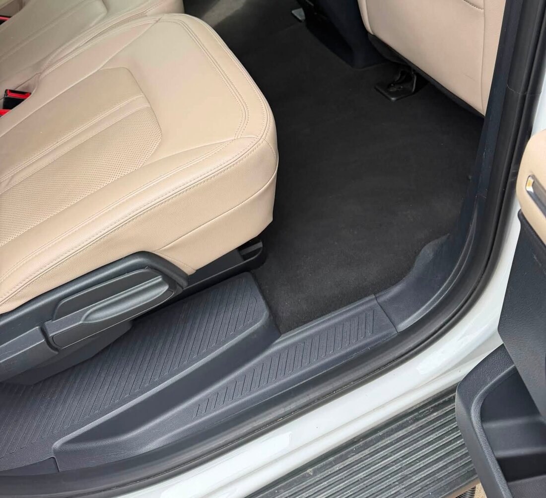 The same second-row floor after detailing, with clean carpet and wiped-down trim